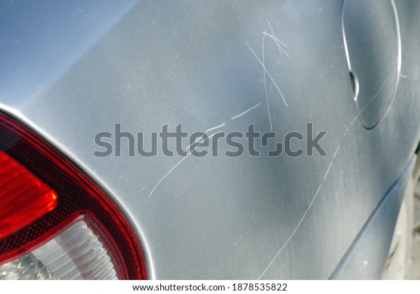 a scratched car\
hood, deep hood scratch,