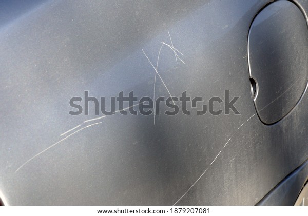 a scratched car\
hood, deep hood scratch,