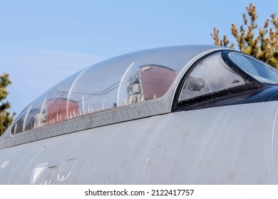 Scratched cockpit canopy on military fighter jet on display in public park. - Powered by Shutterstock
