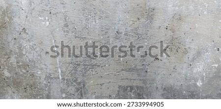 Scratched Gray Concrete Surface Texture with Random Marks. Gray concrete surface filled with scratches and random marks, creating a raw industrial abstract background