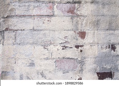 Scratched Peeling Old Paint On Exposed Brick Wall