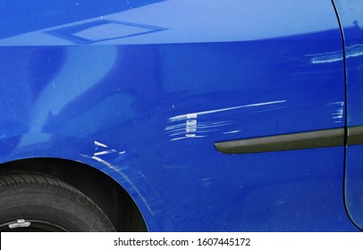 Scratches And Dents On A Blue Car. Accidental Damage To A Car