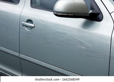 A lot of scratches on a car close up