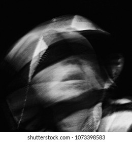 Scream of horror. Screaming woman face. Surreal portrait of a mysterious young woman. Black and white photo. Shot with long exposure. - Shutterstock ID 1073398583