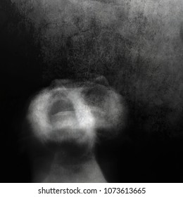 Scream of horror. Screaming woman face. Surreal portrait of a mysterious young woman. Black and white photo. Shot with long exposure.