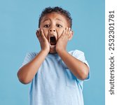 Scream, shocked and portrait of child in studio for information, announcement and facial expression. Scared, kid and face of little boy with emoji reaction for fear, terror or news by blue background