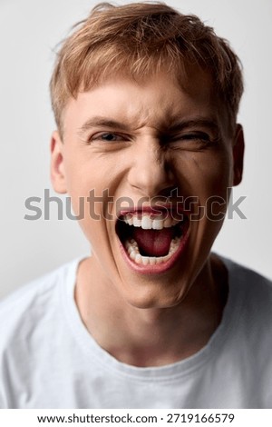 Scream, shouting, anger, expression, close up, male, youth, energy, emotion, mouth open in a loud yell, capturing raw intensity, dynamic facial moment, bold mood for urgency, drama or expressive