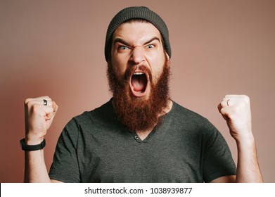 Screaming Bearded Brutal Man And Looking At The Camera With Hands Up, Goal, Winner, Celebrating. Face Expression. Crazy Man With Beard.