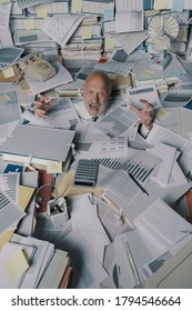 Screaming businessman drowning under a lot of paperwork in the office, he is overwhelmed by work and going insane