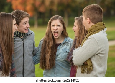 Screaming Female Teen With Group Of Startled Friends