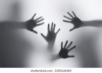 Screaming ghost faces and hands. Blurry hand and body figure. Horror person. Horror ghost screaming behind the glass. Halloween background. Shadowy figure hands behind glass. Horror background. 