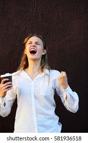 Screaming girl with cup coffee