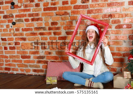 Screaming girl sitting on the floor with a red frame in the hand
