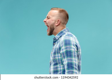 Screaming, Hate, Rage. Crying Emotional Angry Man Screaming On Blue Studio Background. Emotional, Young Face. Male Half-length Portrait. Human Emotions, Facial Expression Concept. Trendy Colors