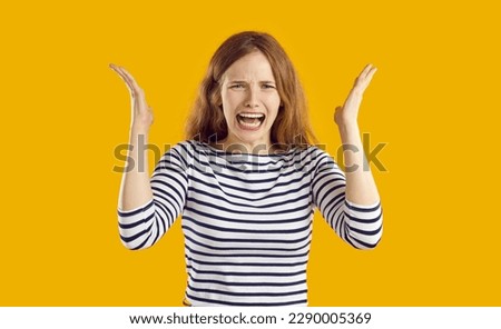 Screaming, hate, rage. Portrait of crying emotional young woman who is screaming feeling angry and furious. Crazy frustrated caucasian girl screaming and shouting isolated on orange background.