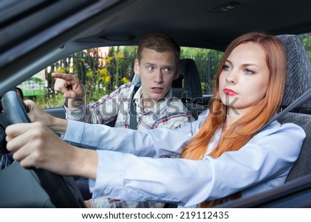 Screaming man and driving woman in a car