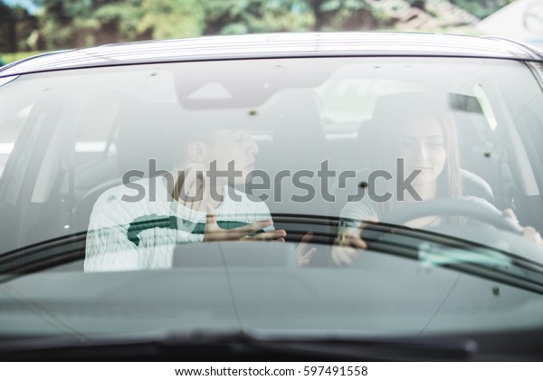 Screaming\
man and driving woman in a car. Woman\
driver
