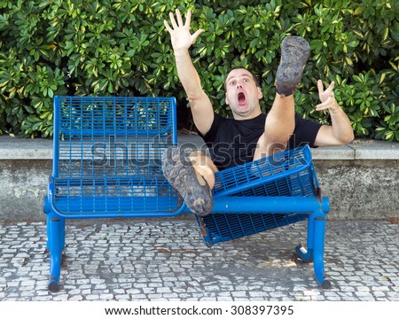 Screaming man falls down from a damaged bench in the park. Shocked tourist has accident on the trip while relaxing.