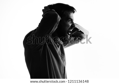 Similar – Desperate man hides eyes behind his hand