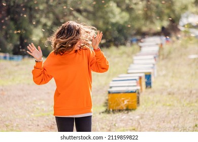 Screaming Woman Was Attacked By An Aggressive And Dangerous Swarm Of Killer Bees In A Honey Apiary. The Concept Of Allergy And First Aid After Being Stung By Insect Venom.