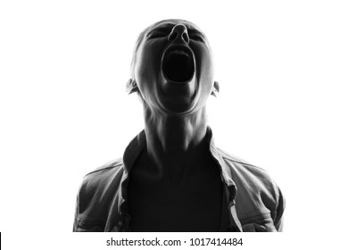 Screaming woman silhouette,back lit light - Shutterstock ID 1017414484