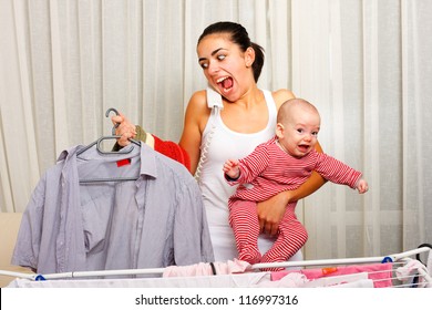 Screaming Young Mother Fed Up With Doing The Laundry, Holding Her Crying Child And Talking On The Phone In The Same Time.