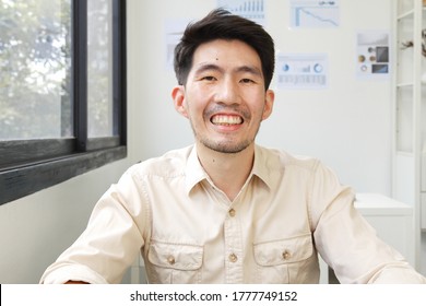 Screen Of Asian Businessman Talking While Video Call Or Virtual Meeting In Office, Front View Look At Laptop Web Camera