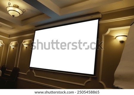 Screen display for creative design, advertisement free space. Large projection screen on beige wall, presentation board, blank whiteboard on conference. Advertising mockup concept. Copy ad text space