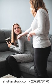 Screen Time Fight - Teenage Daughter Unhappy About Her Mother Limiting Her Screen Time On A Tablet Computer