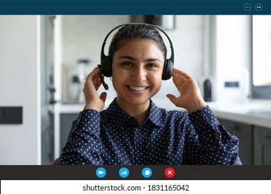 Screen view close up headshot portrait of smiling young Indian female agent in earphones talk consult client customer online. Happy ethnic woman have webcam digital virtual conference or web meeting. - Shutterstock ID 1831165042