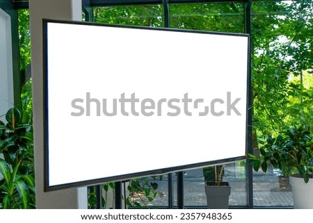 Screen with a white background in a conference room. TV set with place for text. Copy space mockup template. Screen in room interior