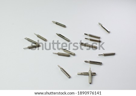 Screw driver with screwer set on white background stack and flow spread on the floor for engineer to fix something
