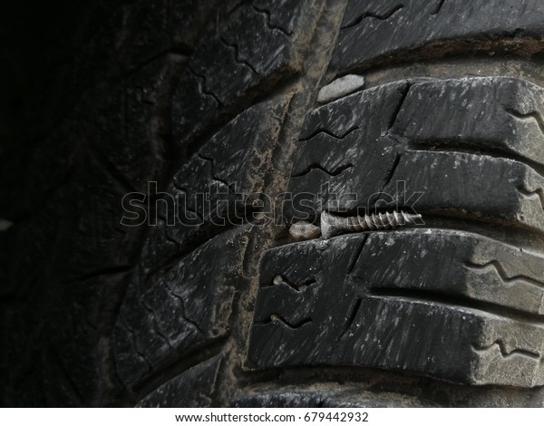 Screw punctured car\
tire