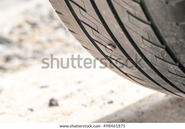 screw puncturing car\
tire