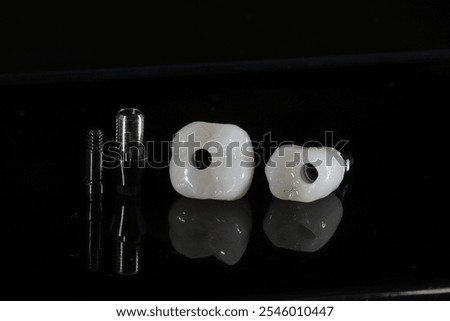 Screw retained single-tooth prosthesis produced by a dental technician on an implant. Zirconium implant tooth made with porcelain.