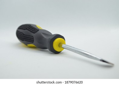 screwdriver, close up photo of black-yellow screwdriver on isolated white background