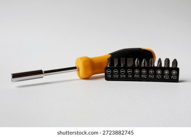 screwdriver handle and a set of screwdriver bits on a white background