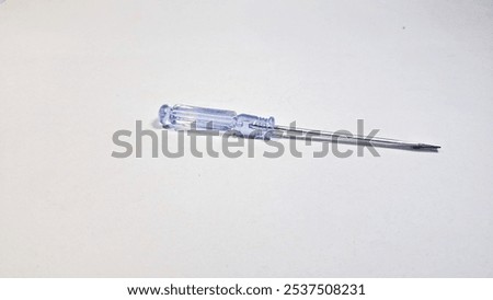 Screwdriver. Mini screwdriver isolated white background. A screwdriver is a simple and common tool used to install or remove screws.
