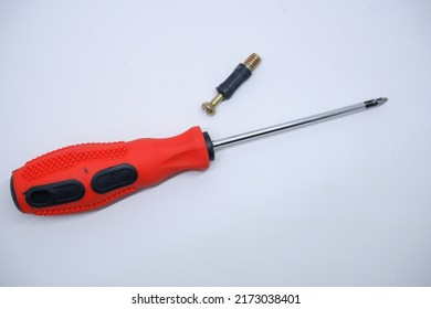 A Screwdriver And A Screw On A White Background. This Tool Is Intended To Fasten Two Objects Together.