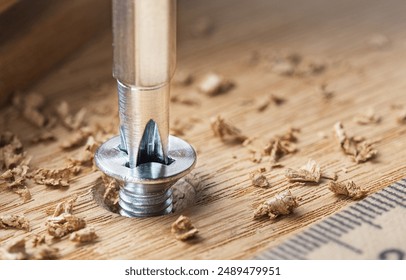 screwdriver screw in a wood oaks plank