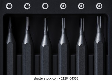 Screwdriver tips different shapes and sizes close up. Manual metal mini screwdriver and set of the interchangeable bits. Precision Screwdriver Kit. Steel Precision Magnetic Bits