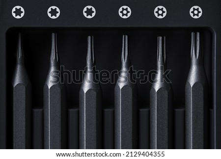 Screwdriver tips different shapes and sizes close up. Manual metal mini screwdriver and set of the interchangeable bits. Precision Screwdriver Kit. Steel Precision Magnetic Bits