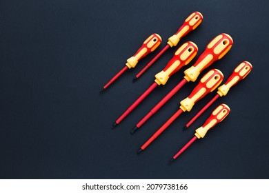 
Screwdrivers. A set of bright colored screwdrivers on a dark background. Repair and renovation concept. Copy space.
