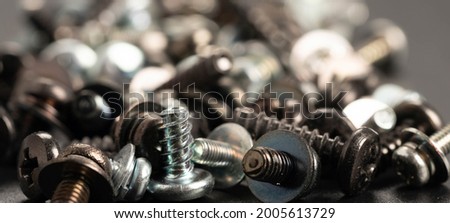Screws and bolts fasteners industrial black background