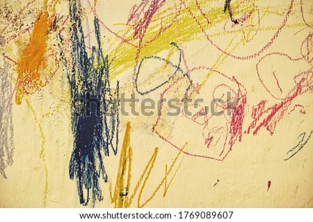 scribble on a wall by a child.  Photos of abstract images on the wall