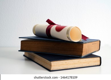 Scroll of certificate on top of the books with copy space , White background.  - Shutterstock ID 1464178109