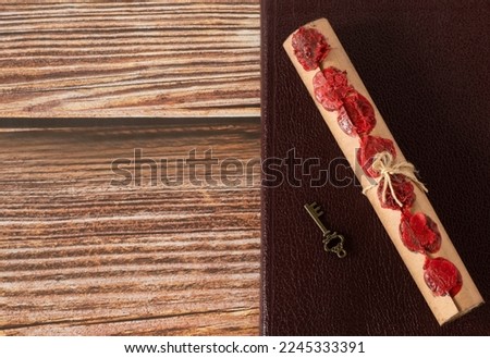 Scroll with seven seals and ancient key on top of closed holy bible book on wooden table. Top view. Copy space. Christian prophecy, revelation, apocalypse, judgment day of God Jesus Christ.