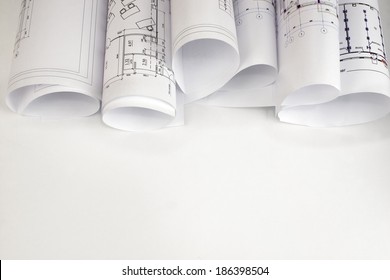 Scrolls of architectural drawings. The desk architect