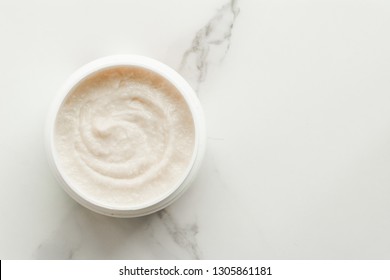 Scrub and exfoliating cream products on a marble, flatlay - skincare and body care, luxury spa and clean cosmetic concept. Health and beauty of your skin