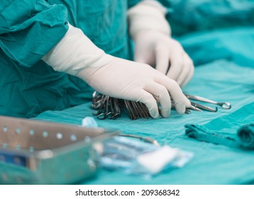 scrub nurse preparing tools for operation - Shutterstock ID 209368342
